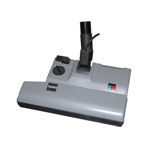 Graue Taski Elektrosaugbürste mit Schalter und Lämpchen.