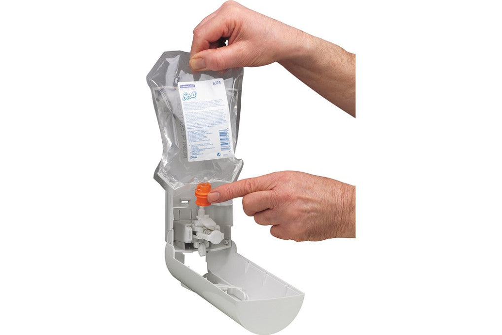 Ein Händedruck setzt einen Toilettensitzreiniger aus einem Spenderbeutel frei.